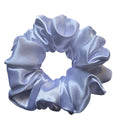 White satin scrunchie on a light gray background